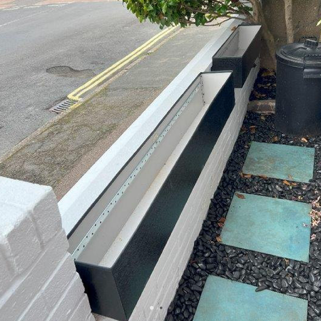 anthracite planters on a front wall 